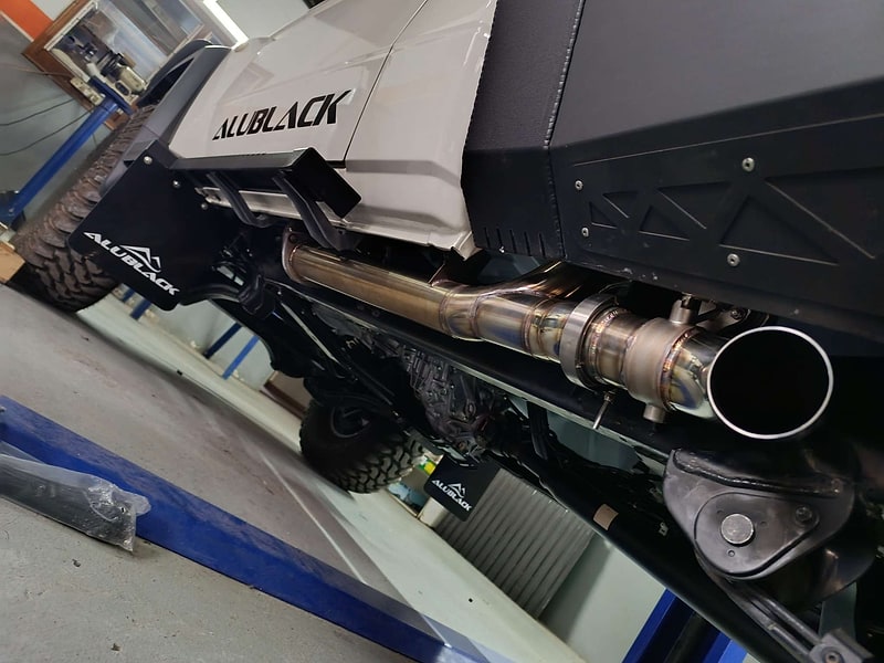 Custom side-exit performance exhaust fitted under a 4x4