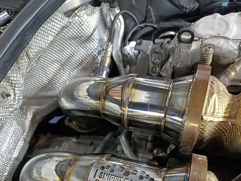 Twin TIG-welded high-flow downpipes with SNIPER Racing branding